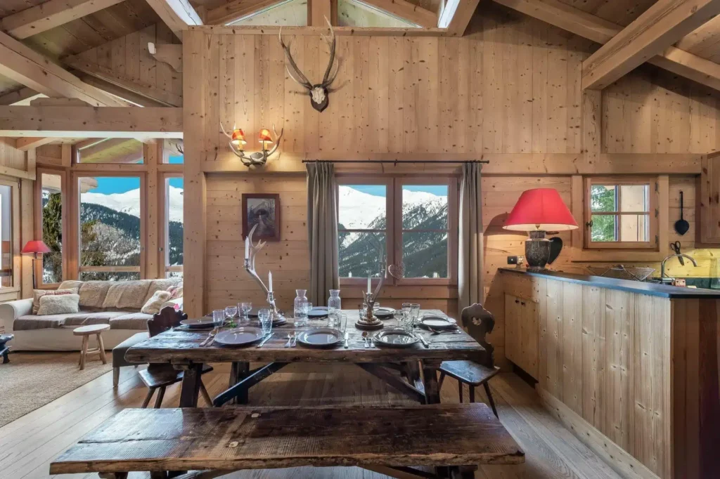 Rustic dining area and lounge with mountain views at Chalet La Biche, a chalet for 12 guests in Courchevel Village