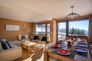 Luxury family holidays in the French Alps 12 Chalet Saule in Arc 1600 - lounge and dining area with valley view