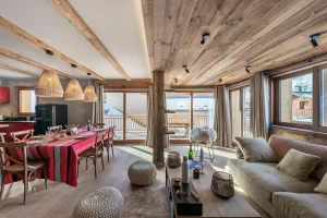 Open living area with dining room, lounge and large windows onto the balcony at Apartment Campanule in Saint-Martin-de-Belleville
