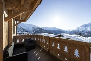 Timber balcony with cut-out fir-tree balustrade and views of the Haute-Tarentaise, at Apartment des Eucherts