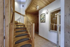 Entrance hall and timber staircase serving the levels, at Apartment des Eucherts