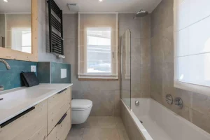 Shower room with a washbasin and green tiles at Apartment Rhodos