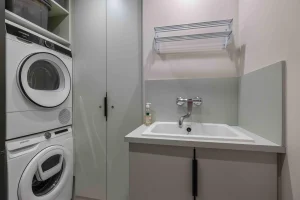 Laundry room with a washing machine and tumble dryer at Apartment Rhodos
