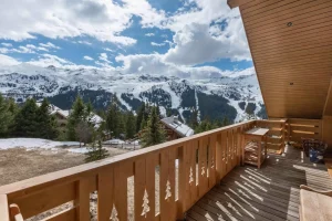 South-facing timber balcony with views of the Méribel mountains from Apartment Rhodos