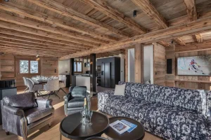 Open living area with lounge, TV, dining room and kitchen at Chalet Arnica in Les Saisies