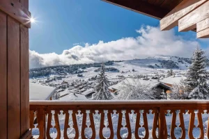 View from the balcony over the resort of Les Saisies and the snow-covered mountains at Chalet Arnica in Les Saisies