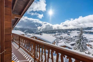 Sunny timber balcony with panoramic views over the resort at Chalet Arnica in Les Saisies