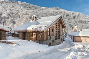 Timber and stone chalet in the snow, a renovated barn in Le Raffort at Chalet Bouleau in Méribel