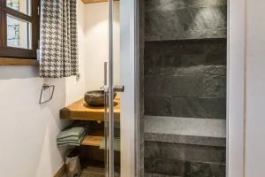 Stone steam shower and a natural stone basin at Chalet Bouleau in Méribel
