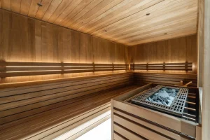 Private timber sauna with a stove and tiered benches at Chalet Brigues in Courchevel Le Praz