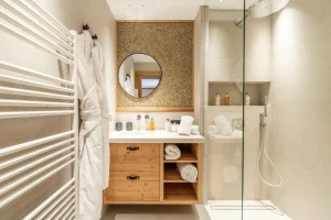 Bathroom with a walk-in shower, a washbasin and a towel radiator at Chalet Brigues in Courchevel Le Praz