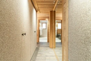 Master suite corridor with built-in wardrobes and a glimpse of the bathroom at Chalet Brigues in Courchevel Le Praz