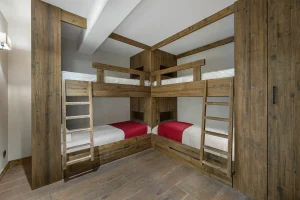 Children's bedroom with two sets of wooden bunk beds at Chalet du Plantin in Méribel Village
