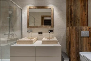 Bathroom with a shower and a double stone washbasin at Chalet du Plantin in Méribel Village