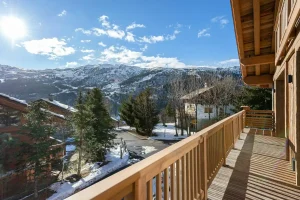 Timber balcony with views of the mountains and the Méribel ski area at Chalet du Plantin in Méribel Village