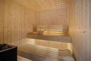 Light timber sauna with illuminated benches at Chalet Églantine in Courchevel La Tania