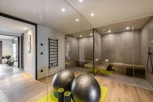 Yoga and wellness area with a glass-fronted hammam and fitness balls at Chalet Merlin in Saint-Martin-de-Belleville