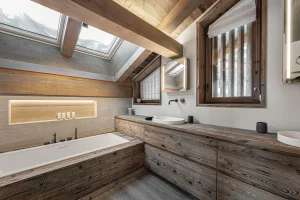 Bathroom with a bathtub, a reclaimed-wood vanity unit and roof windows at Chalet Merlin in Saint-Martin-de-Belleville