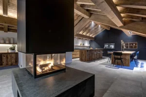 See-through fireplace separating the lounge from the kitchen and dining area