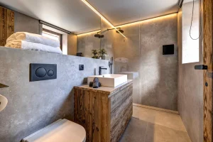 Bathroom with a basin on a timber vanity, a shower and a recessed ceiling light