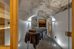 Massage room with a treatment table beneath a stone vault
